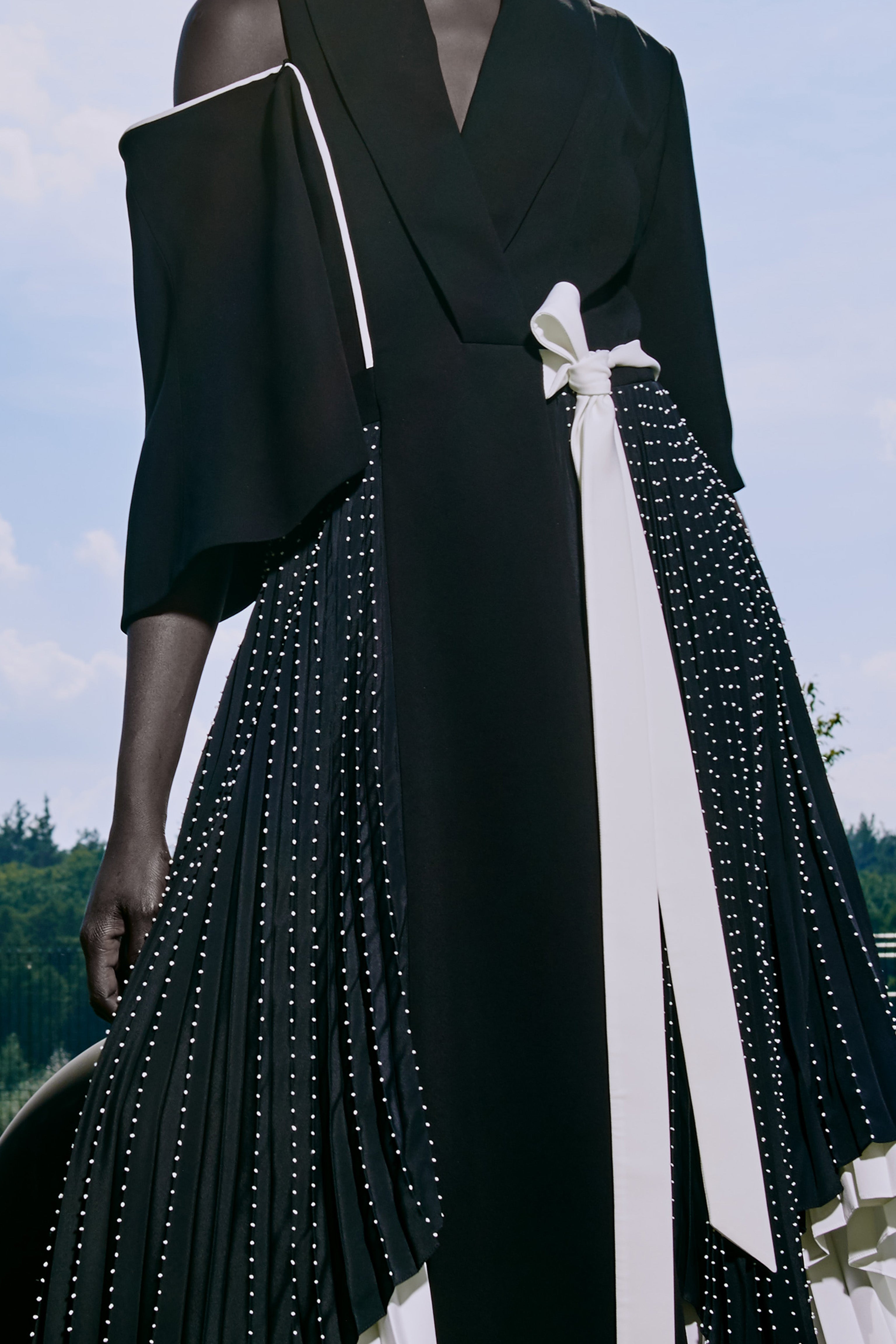 Asymmetric pleated dress with hand embroidery